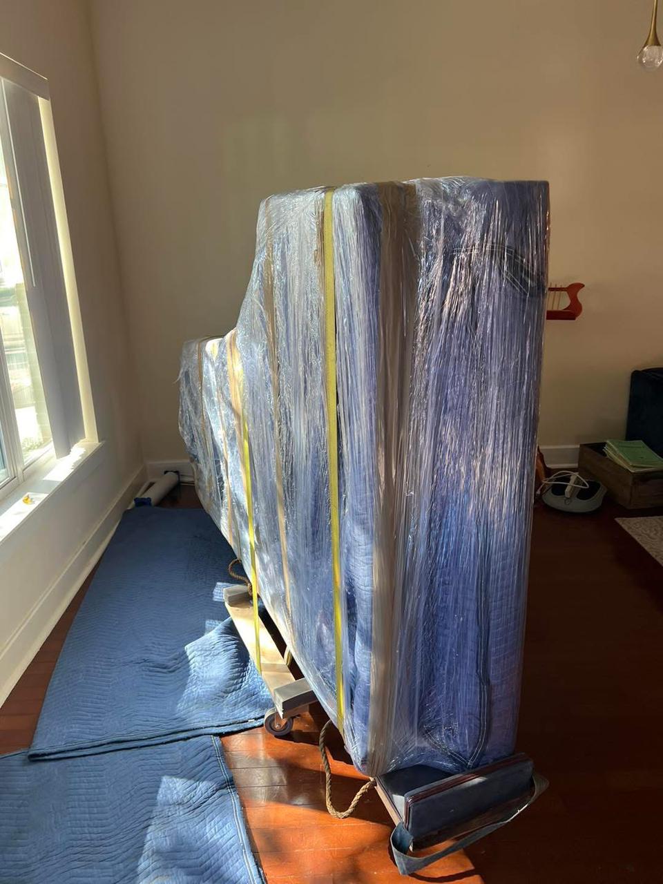 Movers 9 Piano movers carefully loading an upright piano for safe transport in Jacksonville, FL