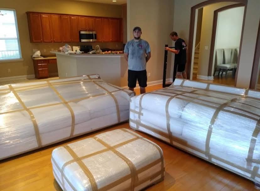Movers 22 Movers wrapping furniture in protective blankets before loading in Jacksonville, FL